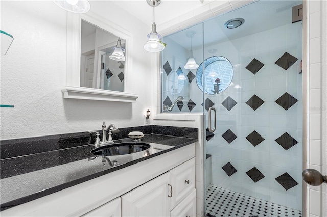 bathroom featuring an enclosed shower and vanity with extensive cabinet space