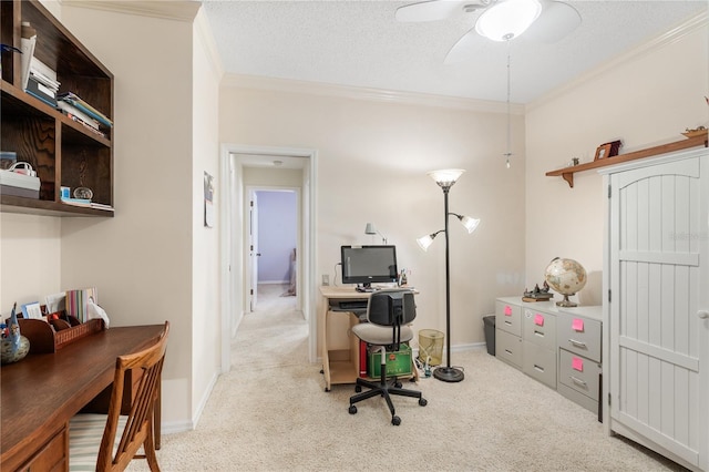 carpeted office space with a textured ceiling, ceiling fan, and ornamental molding