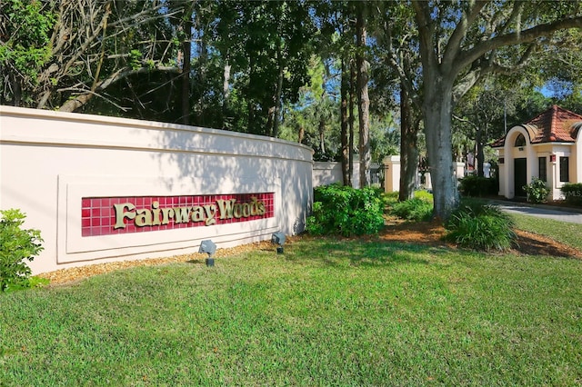 community / neighborhood sign with a lawn