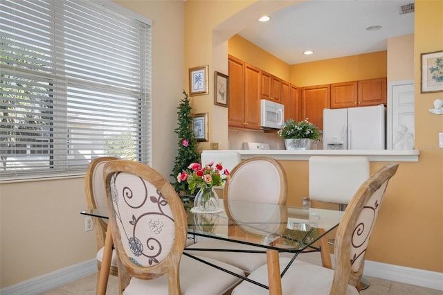 dining space featuring a healthy amount of sunlight and light tile floors