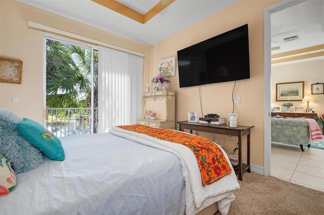 bedroom featuring light tile floors and access to exterior