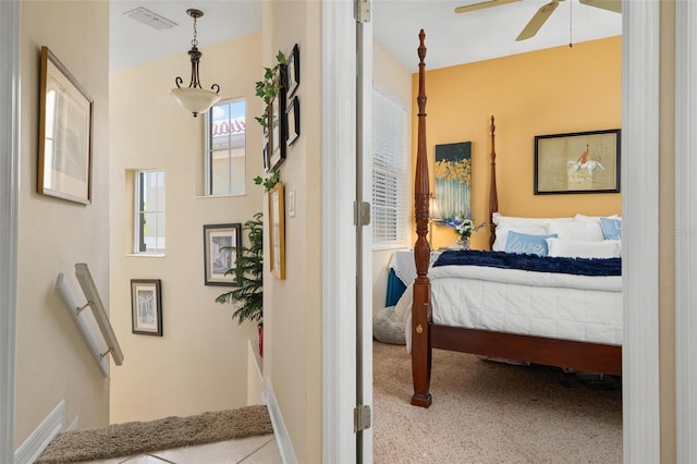 bedroom featuring light colored carpet and ceiling fan