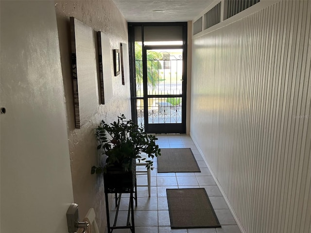 hall featuring tile flooring