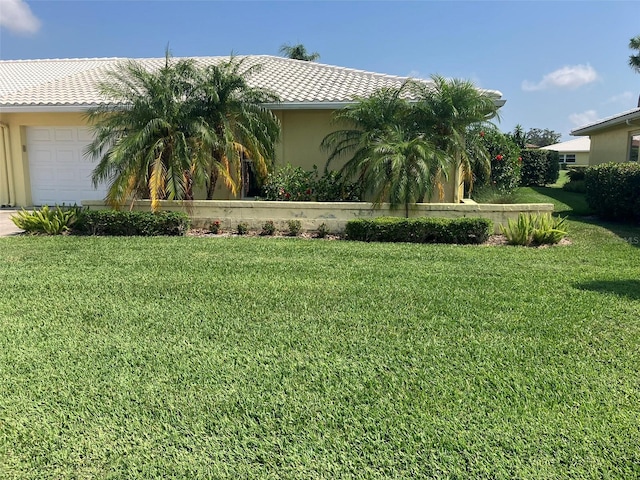 view of front facade featuring a front lawn and a garage