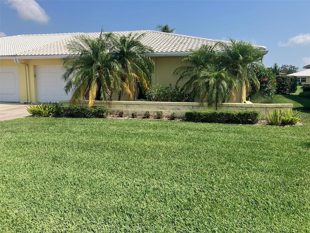 view of home's exterior featuring a garage and a lawn