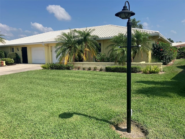 view of front of property with a front lawn and a garage