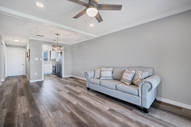 living room with dark hardwood / wood-style flooring, ceiling fan, and ornamental molding