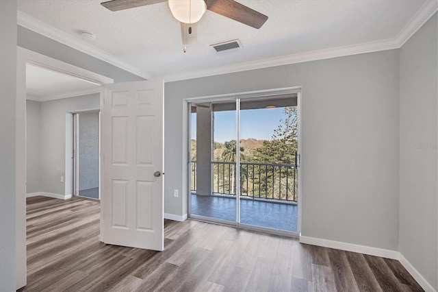 spare room featuring ceiling fan, wood-type flooring, a textured ceiling, and ornamental molding