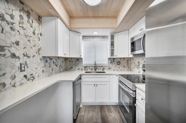 kitchen featuring white cabinets, appliances with stainless steel finishes, dark hardwood / wood-style floors, and sink