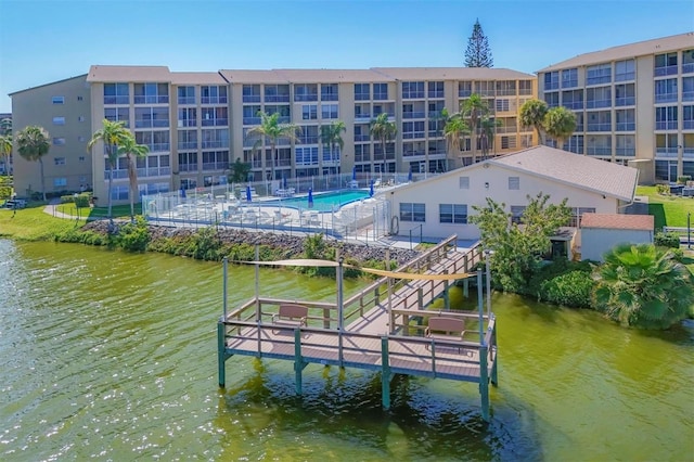 dock area featuring a community pool and a water view