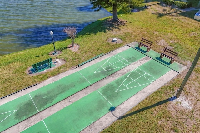 view of community featuring a water view and a lawn