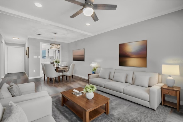 living room with ceiling fan, crown molding, and wood-type flooring