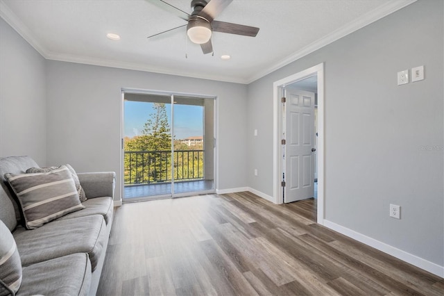 unfurnished living room with hardwood / wood-style flooring, ceiling fan, and crown molding