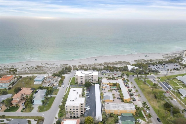 drone / aerial view featuring a water view and a view of the beach