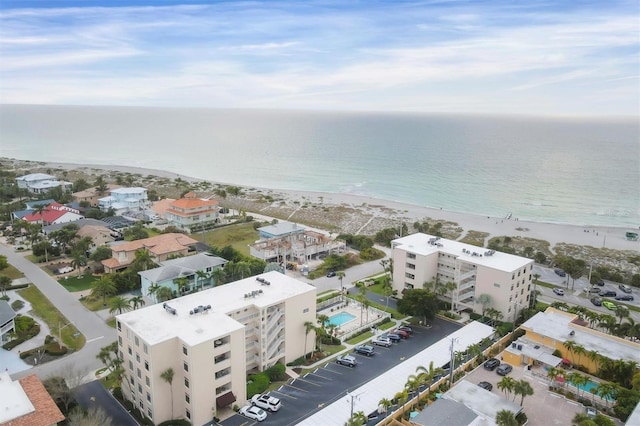 bird's eye view with a water view and a beach view