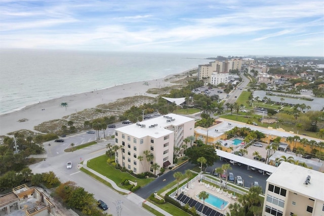 drone / aerial view featuring a water view and a view of the beach