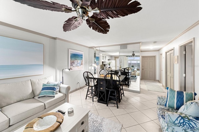 tiled living room with ornamental molding and ceiling fan