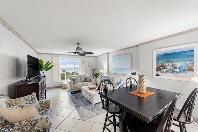 tiled dining area with ceiling fan and ornamental molding