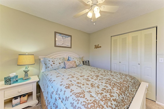 bedroom with light carpet, a textured ceiling, a closet, and ceiling fan