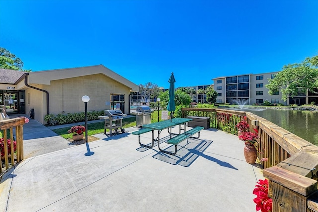 view of patio featuring a grill and a water view