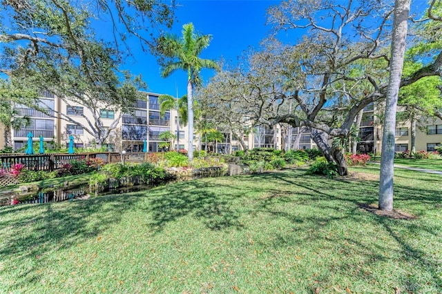 view of property's community featuring a yard