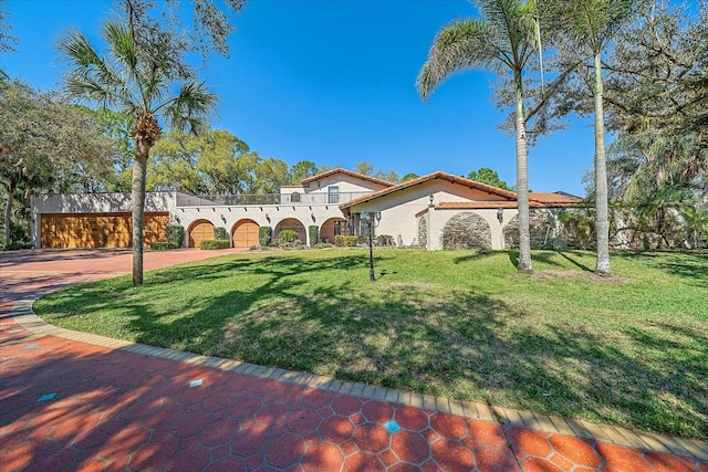 mediterranean / spanish-style house featuring a front yard