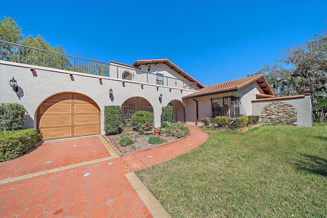 mediterranean / spanish home featuring a balcony and a front yard