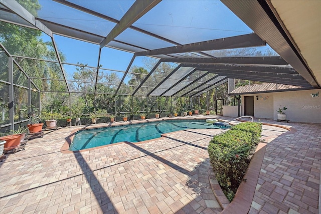 view of swimming pool with a lanai and a patio area