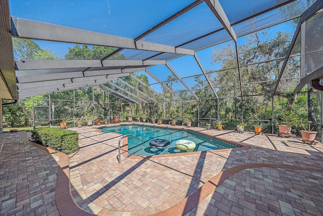 view of swimming pool featuring glass enclosure and a patio area