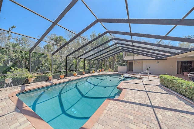 view of swimming pool featuring a patio area and glass enclosure