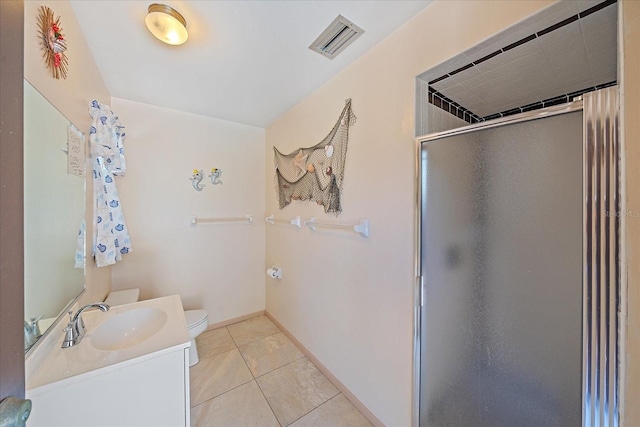 bathroom with tile patterned flooring, vanity, toilet, and a shower with shower door