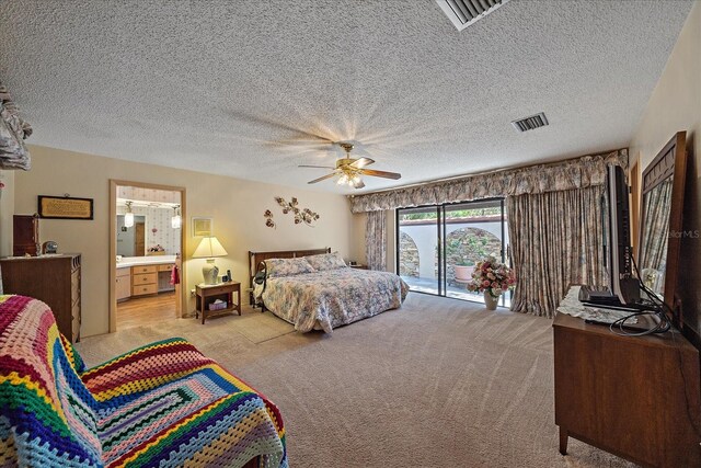 carpeted bedroom featuring ceiling fan, ensuite bathroom, access to exterior, and a textured ceiling