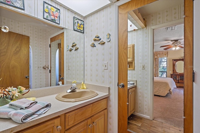 bathroom featuring hardwood / wood-style flooring, vanity, and ceiling fan