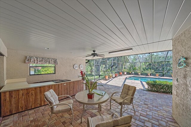 view of patio with a lanai and ceiling fan