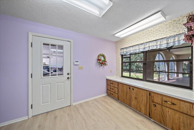 kitchen featuring light hardwood / wood-style floors and a textured ceiling