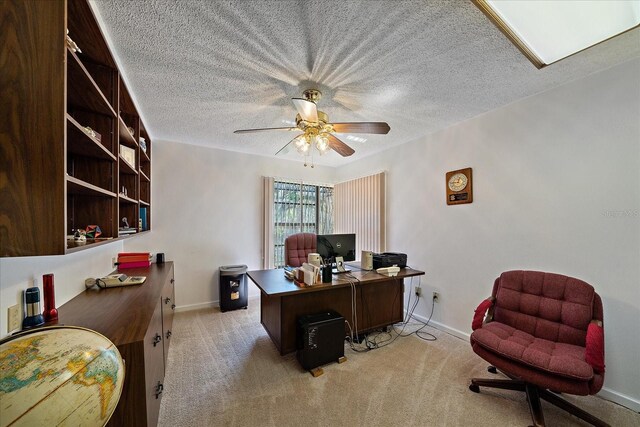 office area featuring light carpet, a textured ceiling, and ceiling fan