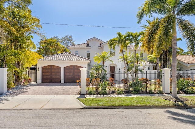 mediterranean / spanish-style house with a garage