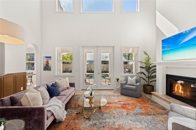 living room featuring french doors and a towering ceiling