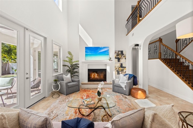 living room with a high ceiling and french doors