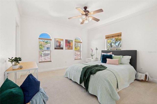 bedroom with ceiling fan, light colored carpet, and ornamental molding