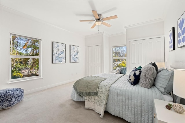 carpeted bedroom featuring ceiling fan and ornamental molding