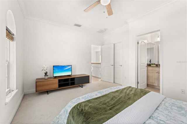 carpeted bedroom featuring connected bathroom, ceiling fan, and crown molding