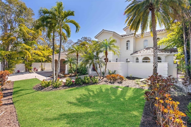 mediterranean / spanish-style home featuring a front yard