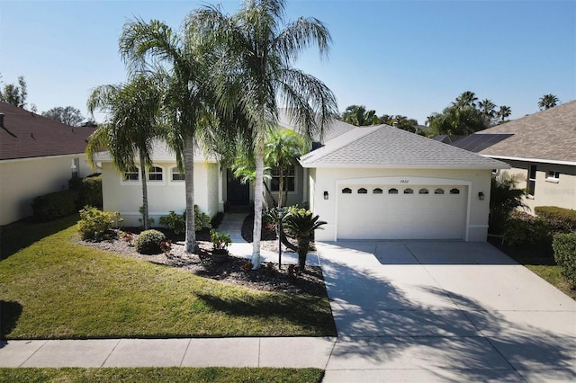 ranch-style house featuring a garage and a front lawn