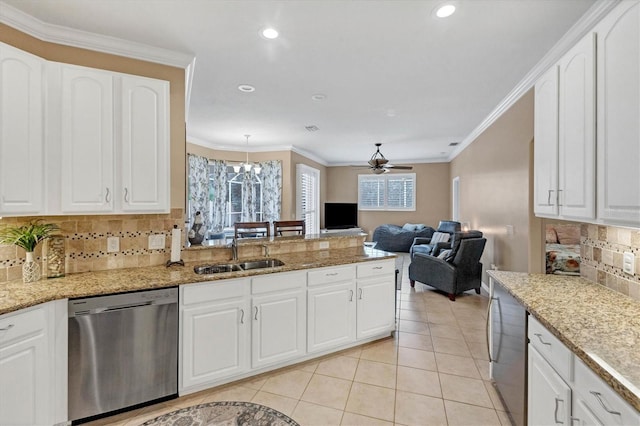 kitchen featuring a wealth of natural light, backsplash, sink, and dishwasher