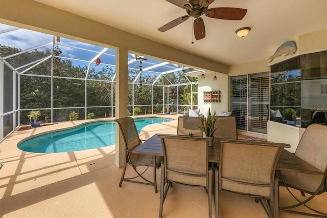 view of pool featuring ceiling fan, glass enclosure, and a patio