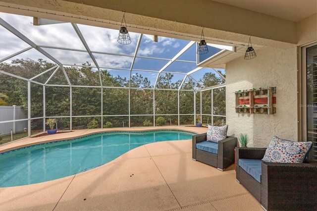 view of swimming pool with glass enclosure and a patio area