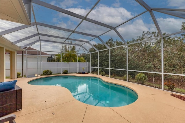 view of swimming pool featuring a lanai and a patio area