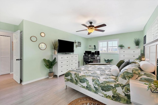 bedroom featuring light hardwood / wood-style floors and ceiling fan