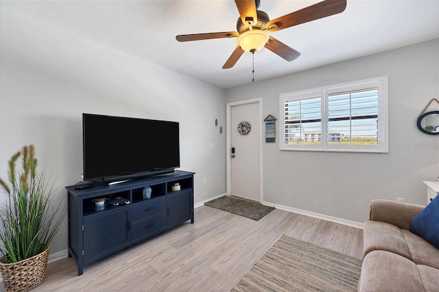 living room with ceiling fan and light wood-type flooring